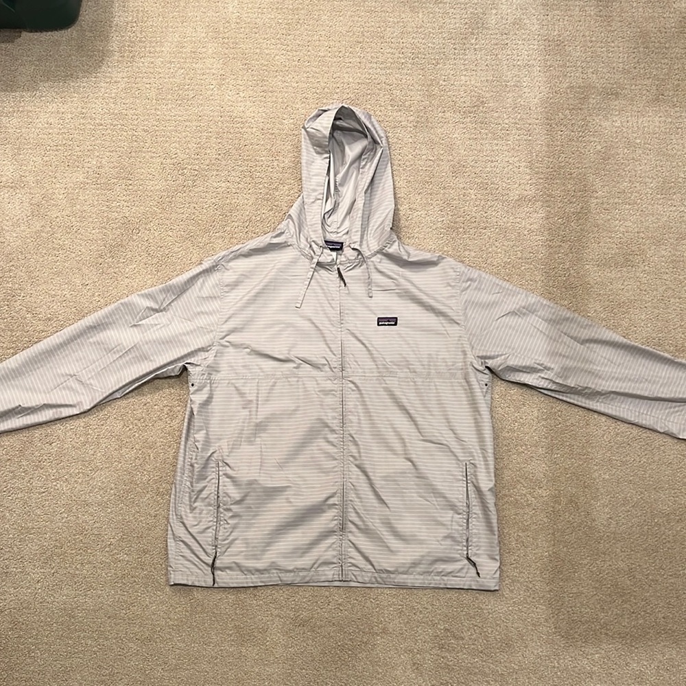 Mens light grey Patagonia hooded light weight windbreaker with white stripes